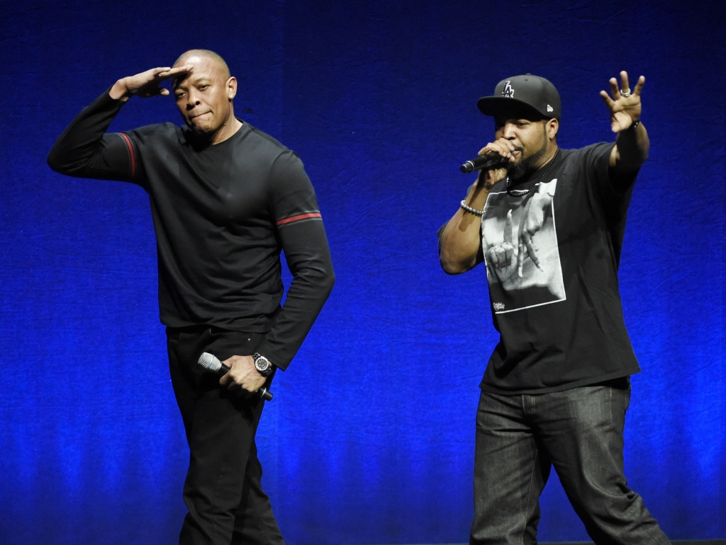 N.W.A. members Dr. Dre left and Ice Cube two of the subjects of the upcoming biographical drama'Straight Outta Compton' salute the crowd after speaking at the Universal