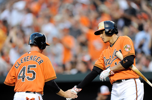 BALTIMORE MD AUGUST 22 Steve Clevenger #45 of the Baltimore Orioles celebrates with Manny Machado #13 after scoring in the second inning against the Minnesota Twins at Oriole Park at Camden Yards