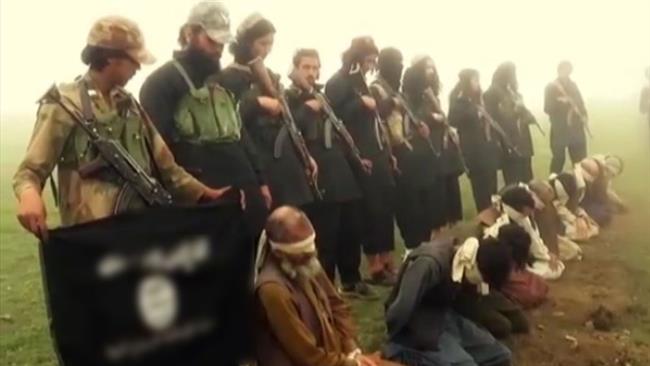 A scene captured from an ISIL video purportedly shows Afghan tribesmen kneeling on the ground moments before their execution