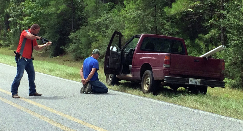 A Mississippi Bureau of Investigation agent detains a person of interest after shots were reportedly fired a second consecutive day Wednesday near Camp Shelby Mississippi