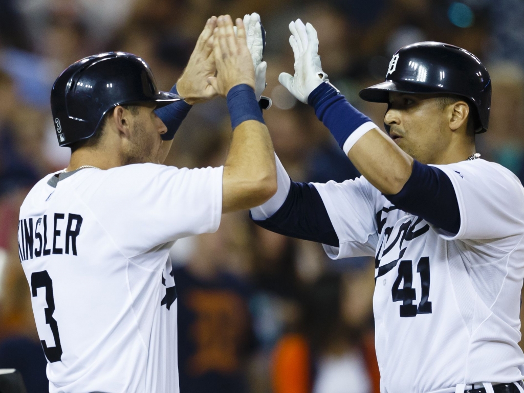 Detroit Tigers designated hitter Victor Martinez receives congratulations from second baseman Ian Kinsler after hitting a two-run home run in the seventh inning against the Boston Red Sox at Comerica Park. Rick Osentoski-USA TODAY Sports