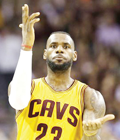 Cleveland Cavaliers forward Le Bron James celebrates a play against the Golden State Warriors during the second half of Game 3 of basketball's NBA Finals in Cleveland Tuesday