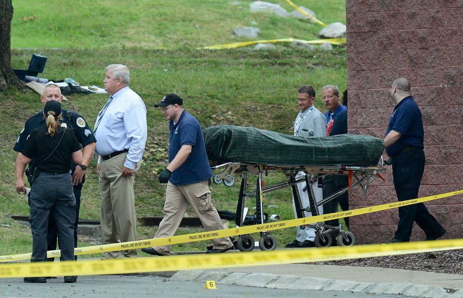 The body of the suspect is removed from a movie theater following a shooting Wednesday Aug. 5 2015 in Antioch Tenn. A man armed with a hatchet and pellet gun unleashed a volley of pepper spray at audience members inside the movie theater exchanging