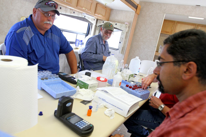 New Mexico Environment Department engineers technicians and scientists test the people's water on Monday Aug. 10 2015 at San Juan County's Lee Acres Sheriff's substation in Farmington N.M. Water laced with heavy metals including lead and arsenic