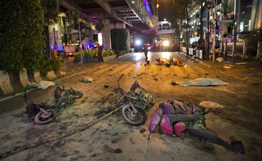 Wreckage of motorcycles are seen as security forces and emergency workers gather at the scene of a blast in central Bangkok on Aug. 17