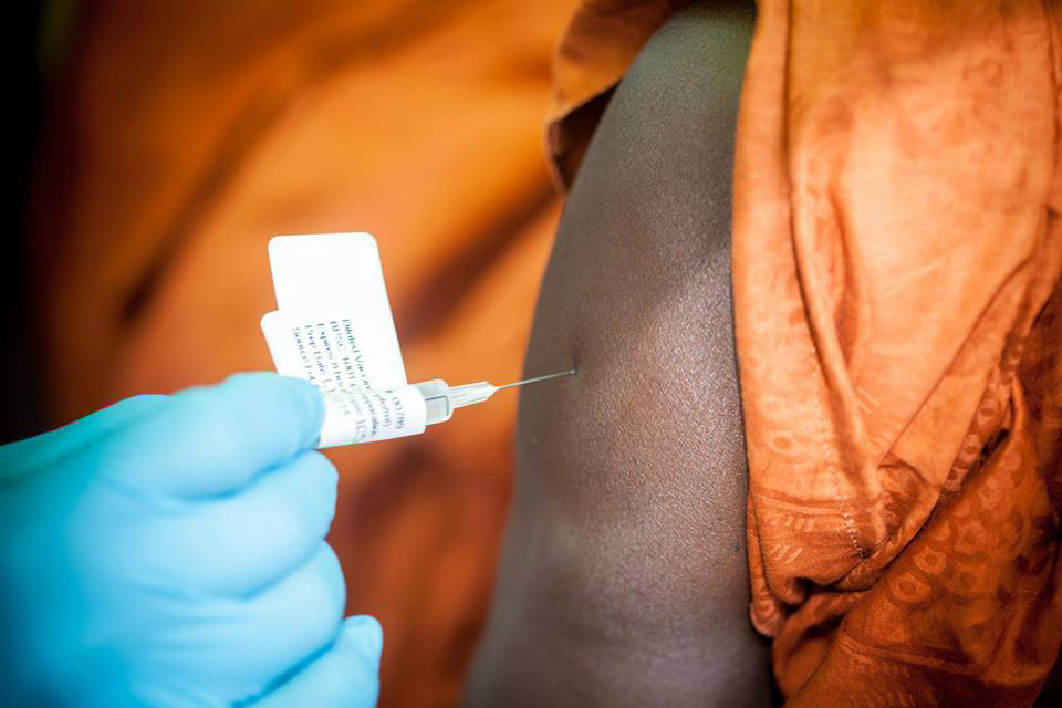 The Ebola vaccine is administered to a participant in the trial in Guinea