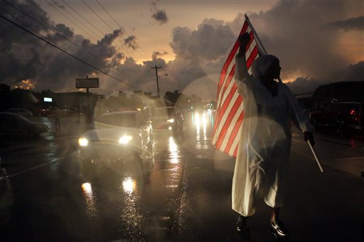 Gina Gowey of Ferguson Mo. protests on West Florissant Ave. Sunday Aug. 9 2015 in Ferguson on the one-year anniversary of Michael Brown being shot and killed by Ferguson Police Officer Darren Wilson