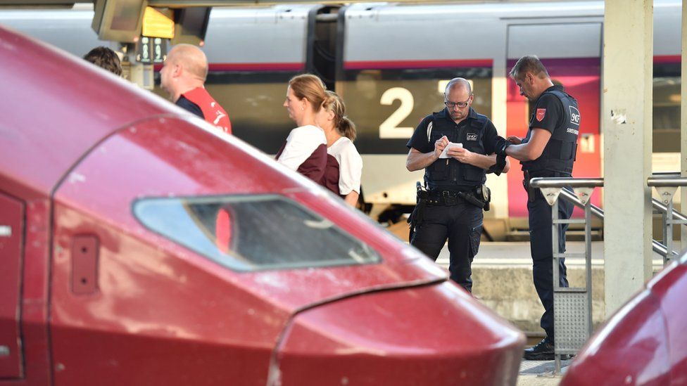 Security agents of French national railway operator SNCF stand next to Thalys trains at the main train station in Arras northern France