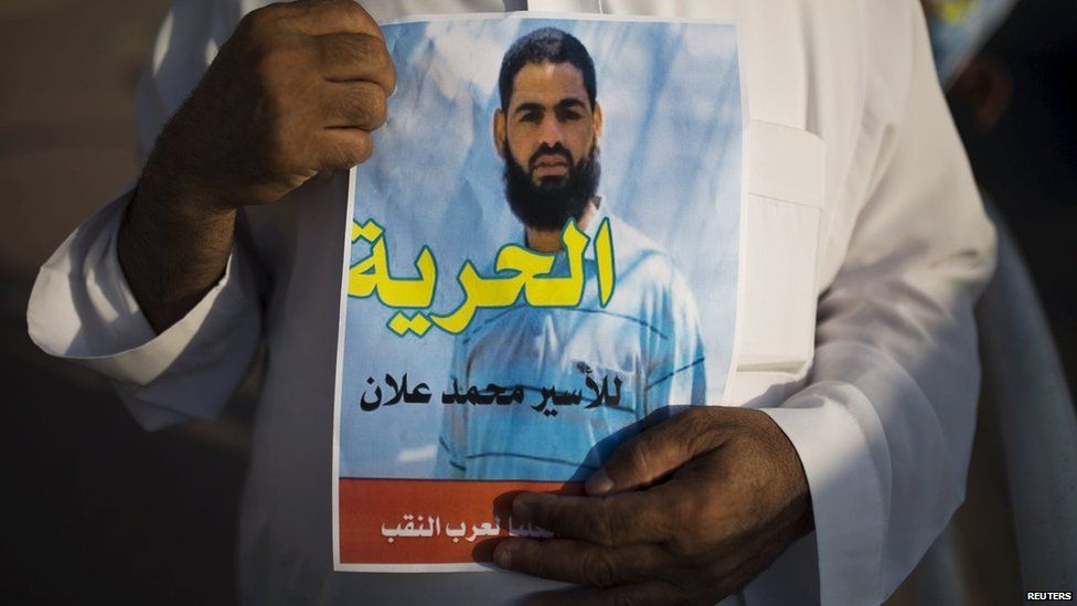 A man holds up a poster demanding freedom for Mohammed Allan in the southern town of Rahat Israel