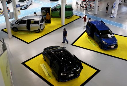 A visitor walks between Toyota Motor Corp's cars displayed at the company's showroom in Tokyo Japan