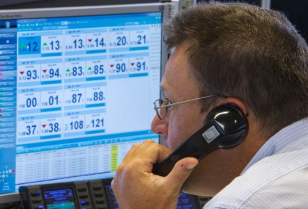 A trader looks at screens on the KBC bank trading floor in Brussels Belgium