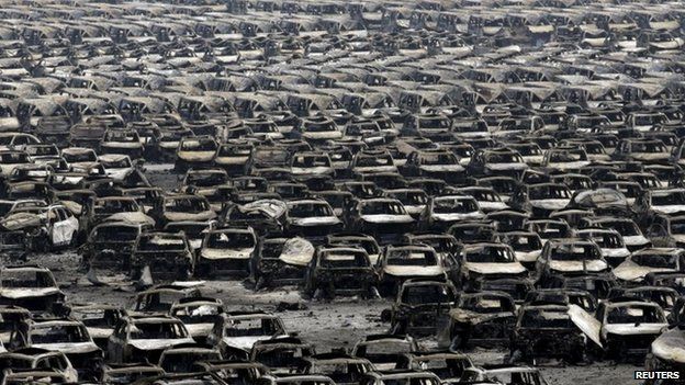 Damaged cars are seen near the site of the explosions at the Binhai new district Tianjin 13