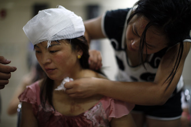 An injured woman is treated inside a hospital following explosions in northeastern China's Tianjin municipality Thursday Aug. 13 2015. Chinese state media reported huge explosions at the Tianjin port late Wednesday. CHINA OUT