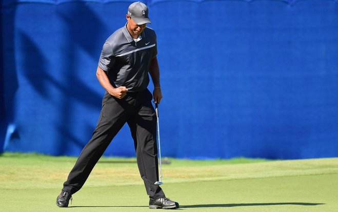 Tiger Woods is all fired up after he sinks an eagle putt on No 15 during his round of 65