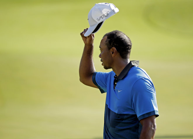 Tiger Woods tips his hat to the crowd on the 18th hole during the second round of the PGA Championship golf tournament