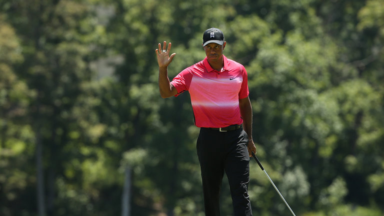 Tiger Woods salutes the crowd after his fifth birdie of the day at the 10th