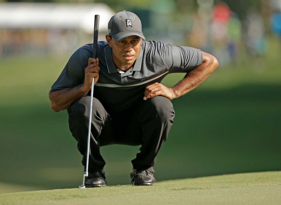 Tiger Woods lines up a putt on the 17th hole during the second round of the Wyndham Championship golf tournament in Greensboro NC