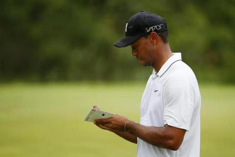 SHEBOYGAN WI- AUGUST 14 Tiger Woods of the United States writes in his scorecard on the 9th hole during the second round of the 2015 PGA Championship at Whistling Straits