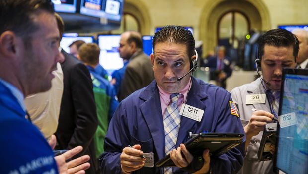 Traders work on the floor of the New York Stock Exchange as the closing bell nears