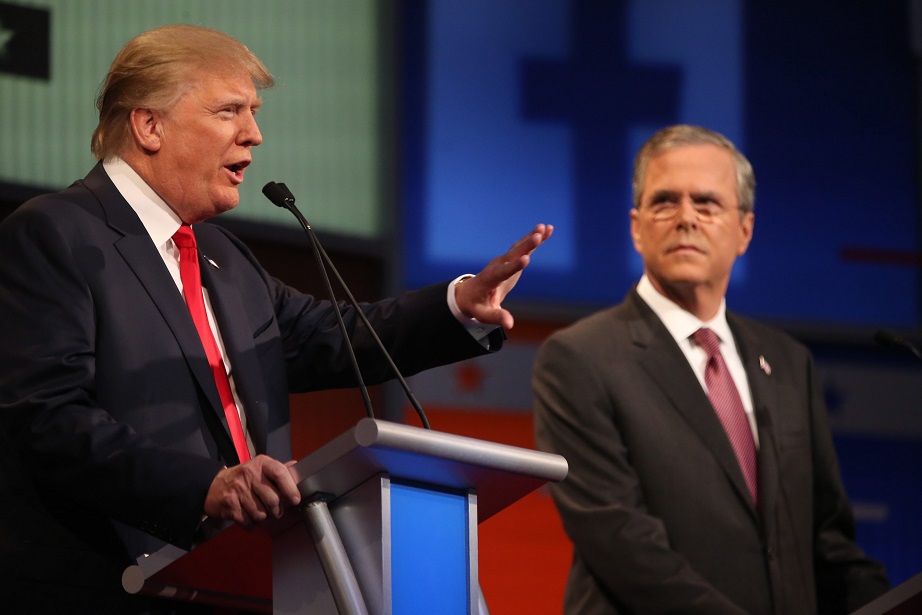 Republican presidential candidate Donald Trump left speaks as Jeb Bush listens during the first Republican presidential debate at the Quicken Loans Arena Thursday Aug. 6 2015 in Cleveland