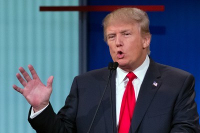 Republican presidential candidate Donald Trump reacts during the first Republican presidential debate at the Quicken Loans Arena Thursday Aug. 6 2015 in Cleveland as Scott Walker is seen at left