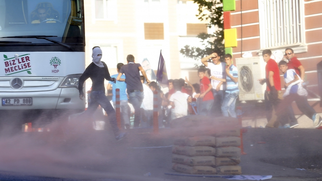 Demonstrators run away from tear gas used by riot police to disperse them during a march in solidarity with Kurdistan Workers Party's jailed leader Abdullah Ocalan in Diyarbakir Turkey yesterday. – Reuters pic