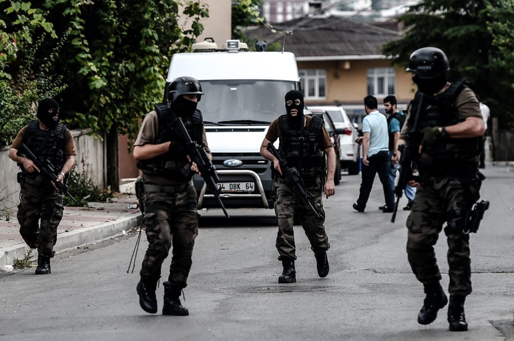 Turkish special police officers patrol in the street after clashes with attackers today at the Sultanbeyli district in Istanbul. The city was shaken by twin attacks on the U.S. consulate and a police station as tensions spiral amid the government's air