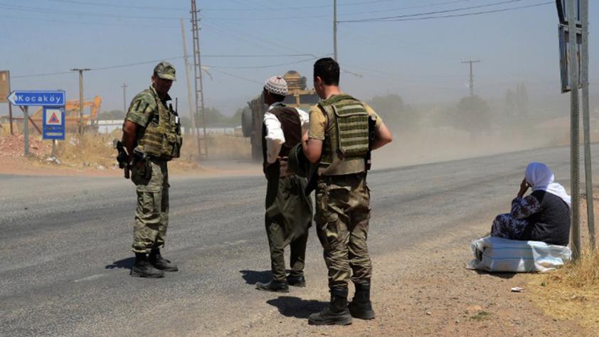 Turkish soldiers wait at a check point in Diyarbakir