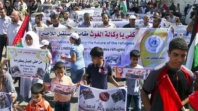 People hold a protest rally against a decision by the United Nations Relief and Works Agency for Palestine Refugees in the Near East to reduce its services in the Gaza Strip