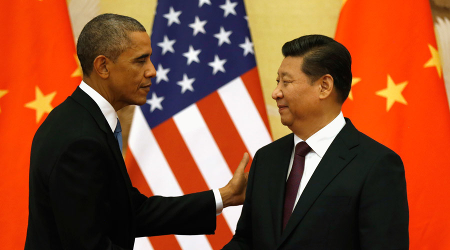 U.S. President Barack Obama pats Chinese President Xi Jinping