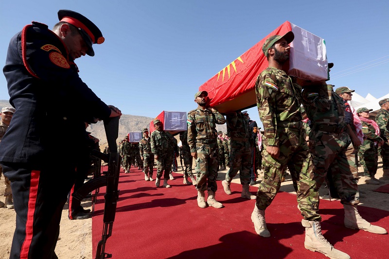 Kurdish peshmerga forces carry coffins containing the remains of Yazidis who were killed by Isis militants US found traces of chemical weapons in Isis mortar fragments pic