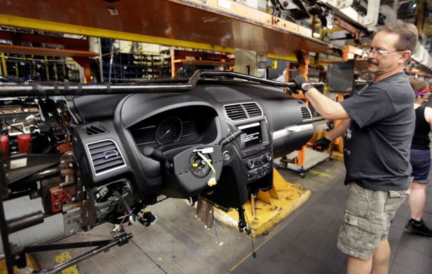 Ford Motor Co. employee works on the instrument panel of a 2016 Ford Explorer at the Chicago Assembly Plant in Chicago. The Commerce Department releases durable goods orders for July on Wednesday Aug. 26 2015