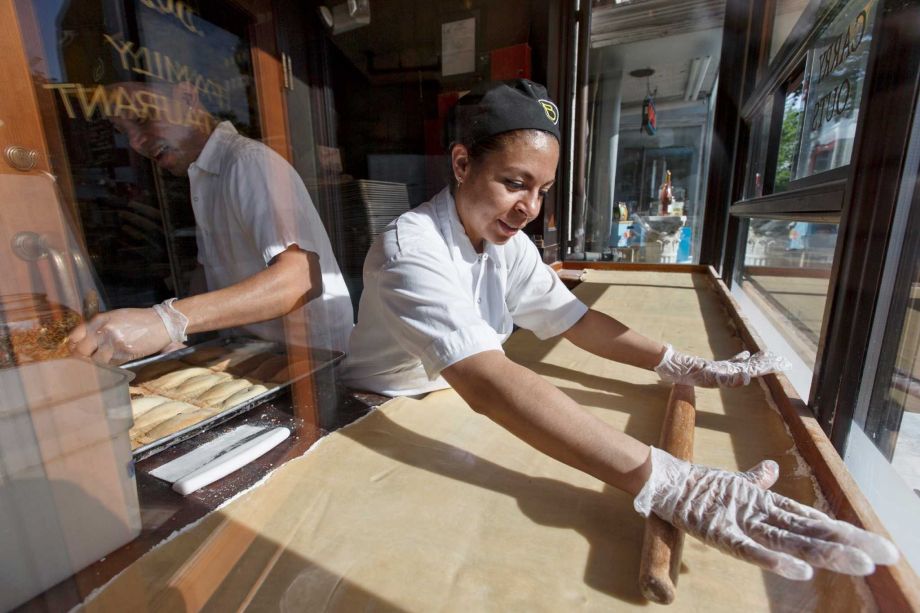 Fatima Godoy rolls out the dough as Gustavo Servellon left applies the sprinkles as they construct pastries at Ted's Bulletin a Capitol Hill restaurant in Washington D.C. A Labor Department report on Friday indicates that companies are still able to