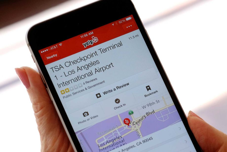 The mobile view of the Yelp site application shown on an iPhone mobile shows the TSA Checkpoint Terminal 1 at the Los Angeles International Terminal location in Los Angeles on Tuesday Aug. 18 2015. Frustrated travelers have already been turning to the