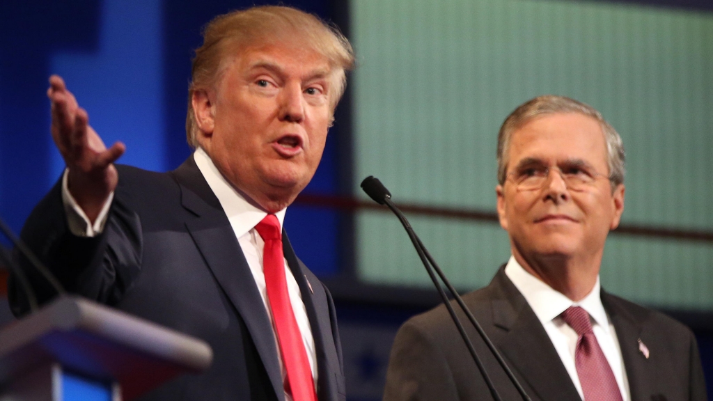 Republican presidential candidate Donald Trump speaks as Jeb Bush listens during the first Republican presidential debate in Cleveland