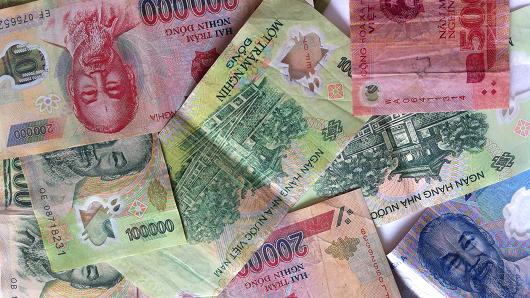 Vietnam devalues currency by 1 percent after China's move