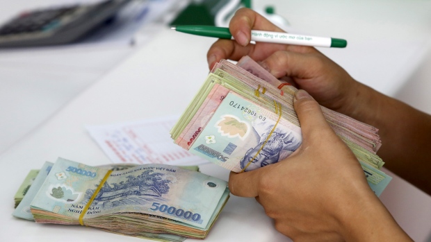 Vietnam's central bank lowered the value of the country's currency on Wednesday a tactic designed to keep up with a similar move by China in recent weeks