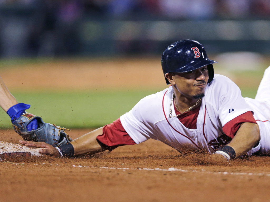 Boston’s Mookie Betts dives back safely under the tag of Kansas City first baseman Eric Hosmer on a pick-off attempt in the seventh inning Thursday at Fenway Park. The Associated Press