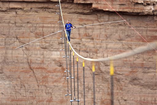 Discovery Channel aerialist Nik Wallenda walks a 2-inch-thick steel cable taking him a quarter mile over the Little Colorado River Gorge Ariz