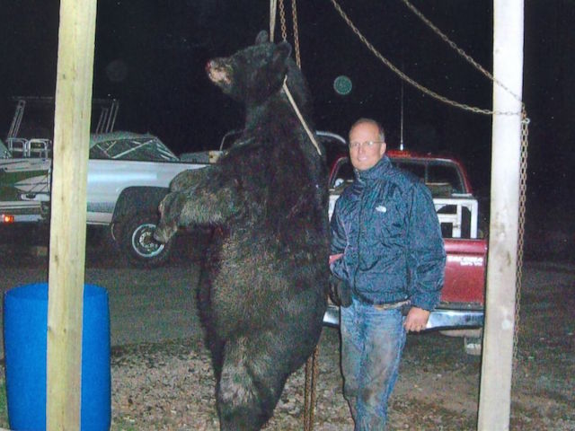 Walter Palmer next to the remains of a bear he killed