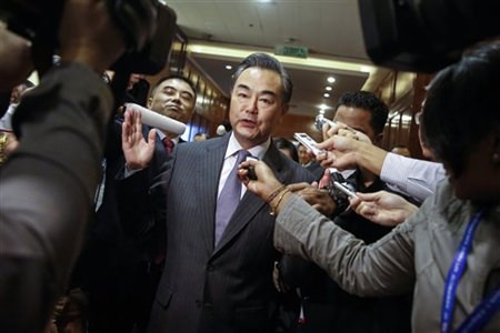 Chinese Foreign Minister Wang Yi is surrounded by journalists at the Association of Southeast Asian Nations Foreign Ministers Meeting in Kuala Lumpur Malaysia Tuesday Aug. 4 2015. Malaysia called Tuesday for more efforts to find a peaceful sol