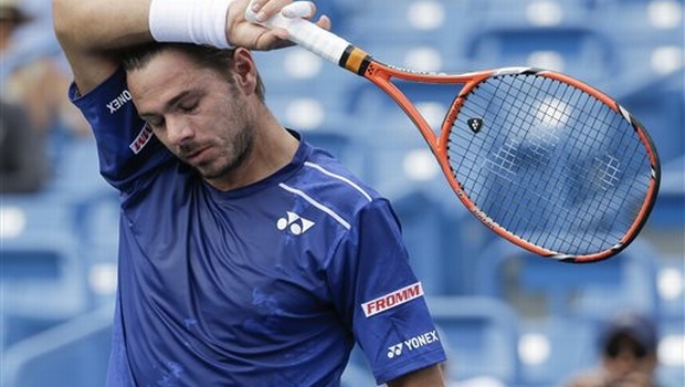 Stanislas Wawrinka of Switzerland wipes sweat from his forehead during his match against Borna Coric of Croatia at the Western & Southern Open tennis tournament