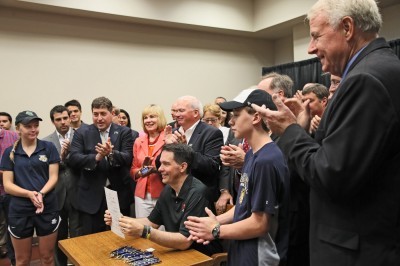 Wisconsin Gov. Scott Walker holds up the Milwaukee Bucks arena financing legislation he signed Wednesday morning