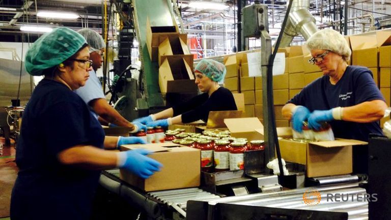 Workers box jars of pasta sauce at a plant run by Chelten House Products in Bridgeport New Jersey