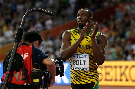 Jamaica's Usain Bolt applauds after finishing in first in a semifinal of the men's 100m at the World Athletics Championships at the Bird's Nest stadium in Beijing Sunday Aug. 23 2015