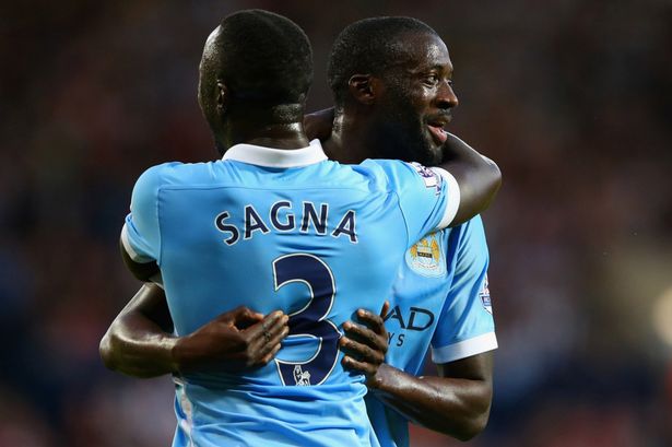 Yaya Toure celebrates with team mate Bacary Sagna after scoring City's second