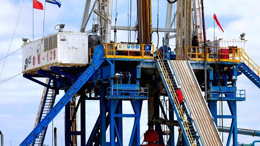 Flags of China and Cuba fly on an oil drilling rig operated jointly by Cuba's state-owned Cupet SA and China's Great Wall Drilling Co. a unit of China National Petroleum Corp. 50 miles northeast of Havana Cuba