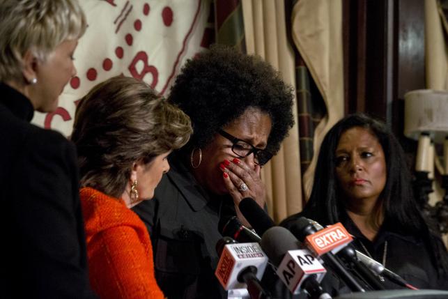 Attorney Gloria Allred comforts Charlotte Fox, who is accusing comedian Bill Cosby of sexual misconduct during a news conference in New York