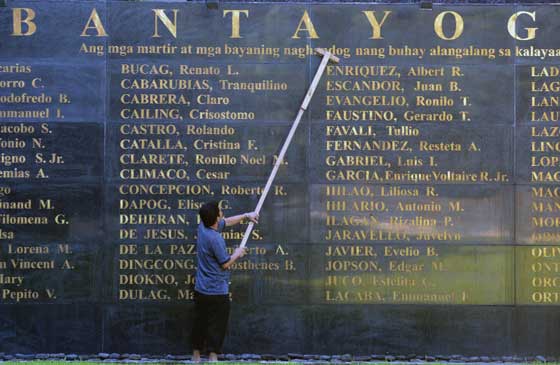 REMEMBER THEM A worker cleans the Bantayog ng mga Bayani in Quezon City on the eve of the 43rd anniversary of the declaration of martial law. The landmark contains the names of victims of martial law