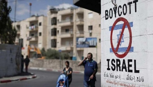 A sign painted on a wall in Bethlehem calling for a boycott of Israeli goods